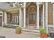 Grand entrance showcasing stone accents and ornate double doors with covered porch at 113 Regents Sq, Peachtree City, GA 30269