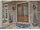 Charming entrance featuring custom double doors, stone detail, and decorative potted plants at 113 Regents Sq, Peachtree City, GA 30269