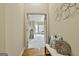 Inviting hallway with decorative pillows on a bench, leading to a bright living space at 113 Regents Sq, Peachtree City, GA 30269