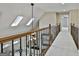 Second story hallway with carpet floors, decorative wrought iron banister and skylights for natural light at 113 Regents Sq, Peachtree City, GA 30269