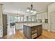Spacious kitchen featuring a large island with granite countertops and dark wood accents at 113 Regents Sq, Peachtree City, GA 30269