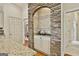 Gourmet kitchen with custom stone archway over the cooktop and granite countertops at 113 Regents Sq, Peachtree City, GA 30269