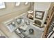 Open-concept living room with stone fireplace, large windows and dining set, viewed from above at 113 Regents Sq, Peachtree City, GA 30269
