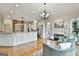 Open-concept living room showcasing a fireplace, hardwood floors, and views into the kitchen at 113 Regents Sq, Peachtree City, GA 30269