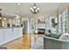 Charming living room featuring a fireplace, hardwood floors, and views of the kitchen at 113 Regents Sq, Peachtree City, GA 30269