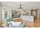 Bright open-concept living room features a fireplace with stone detail and hardwood floors throughout at 113 Regents Sq, Peachtree City, GA 30269