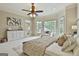 Bright and airy main bedroom with large bay windows, a ceiling fan, and stylish decor at 113 Regents Sq, Peachtree City, GA 30269