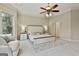 Spacious main bedroom with large windows, a ceiling fan, and a neutral color palette at 113 Regents Sq, Peachtree City, GA 30269