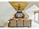 Attic media room with mounted television, leather seating, ceiling fan and wood accent on the ceiling at 113 Regents Sq, Peachtree City, GA 30269