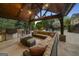 Spacious outdoor kitchen with a grill, stainless steel appliances, ample seating, and a cozy lounge area at 113 Regents Sq, Peachtree City, GA 30269