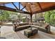Covered patio with comfortable seating, a ceiling fan, and a view of the landscaped backyard and neighboring homes at 113 Regents Sq, Peachtree City, GA 30269