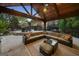 Inviting outdoor patio with comfortable seating, a beautiful pergola, and a cozy fireplace feature at 113 Regents Sq, Peachtree City, GA 30269