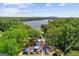 Playground featuring colorful equipment with a beautiful lake view and surrounded by lush greenery at 113 Regents Sq, Peachtree City, GA 30269