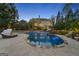 Backyard swimming pool with poolside furniture and lush landscaping at 113 Regents Sq, Peachtree City, GA 30269