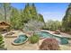Aerial view of a custom pool with mature trees, a spa, and lounge area at 113 Regents Sq, Peachtree City, GA 30269