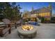 Backyard fire pit area with Adirondack chairs overlooking the pool area, perfect for relaxing evenings outdoors at 113 Regents Sq, Peachtree City, GA 30269