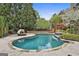 Gorgeous pool featuring custom stonework, lush landscaping, and a unique daybed at 113 Regents Sq, Peachtree City, GA 30269
