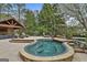 Inviting pool and spa with stone surround, outdoor lounge, and lush landscaping create a relaxing backyard oasis at 113 Regents Sq, Peachtree City, GA 30269