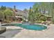 The backyard has a luxurious pool, lounge chairs, and a covered outdoor seating area at 113 Regents Sq, Peachtree City, GA 30269