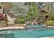 Incredible custom pool and waterfall with lush landscaping and an outdoor kitchen at 113 Regents Sq, Peachtree City, GA 30269