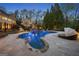Beautiful backyard pool with lush landscaping, a waterfall feature, and comfortable lounge seating, perfect for entertaining at 113 Regents Sq, Peachtree City, GA 30269