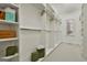 Walk-in closet with custom built-in shelves and multiple hanging rods for ample storage and organization at 113 Regents Sq, Peachtree City, GA 30269