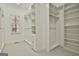 Spacious walk-in closet featuring custom shelving, drawers and a large window for natural light at 113 Regents Sq, Peachtree City, GA 30269