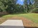 Lush backyard with a concrete patio, ideal for outdoor living at 1110 Saint Phillips Ct, Locust Grove, GA 30248