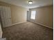 Bedroom featuring carpet, a bright window, and a closet at 1110 Saint Phillips Ct, Locust Grove, GA 30248