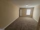 Bedroom features carpet, a bright window, and a closet at 1110 Saint Phillips Ct, Locust Grove, GA 30248