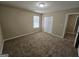 Bedroom with carpet, double door closet, and bright window at 1110 Saint Phillips Ct, Locust Grove, GA 30248