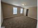 Large bedroom with natural lighting and neutral carpet at 1110 Saint Phillips Ct, Locust Grove, GA 30248