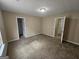 Large bedroom featuring neutral carpet and a standard door at 1110 Saint Phillips Ct, Locust Grove, GA 30248