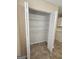 Spacious linen closet featuring adjustable wire shelving and tile flooring at 1110 Saint Phillips Ct, Locust Grove, GA 30248