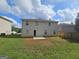 Back exterior view of a two story home featuring backyard and patio at 1110 Saint Phillips Ct, Locust Grove, GA 30248