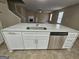 Updated kitchen featuring an island with a stainless steel dishwasher and sink, with open living concept at 1110 Saint Phillips Ct, Locust Grove, GA 30248