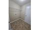 Tile laundry room with hook ups and shelving with a door at 1110 Saint Phillips Ct, Locust Grove, GA 30248