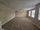 Spacious living room featuring neutral paint, carpeted floors, and a ceiling fan at 1110 Saint Phillips Ct, Locust Grove, GA 30248