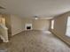 Large living room with a fireplace, neutral walls, and access to the staircase at 1110 Saint Phillips Ct, Locust Grove, GA 30248