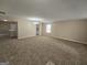 Spacious living room featuring neutral paint, plush carpeting, and a view of the kitchen at 1110 Saint Phillips Ct, Locust Grove, GA 30248