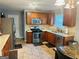 Functional kitchen with stainless steel appliances, granite countertops, and wood cabinetry at 789 Winbrook Dr # 1, Mcdonough, GA 30253
