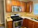 Kitchen with stainless steel oven and microwave, wood cabinets, and granite countertops at 789 Winbrook Dr # 1, Mcdonough, GA 30253