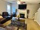 Comfortable living room with a fireplace, ceiling fan, and a large, plush leather sectional at 789 Winbrook Dr # 1, Mcdonough, GA 30253