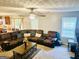 Spacious living room featuring a large leather sectional, ceiling fan, and a view into the kitchen at 789 Winbrook Dr # 1, Mcdonough, GA 30253