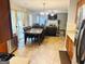 Open-concept living space with dining area and a view into the cozy living room with fireplace at 789 Winbrook Dr # 1, Mcdonough, GA 30253