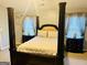 Spacious main bedroom featuring a four-poster bed and neutral decor at 789 Winbrook Dr # 1, Mcdonough, GA 30253