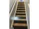 Carpeted stairway with white railings and neutral colored walls at 789 Winbrook Dr # 1, Mcdonough, GA 30253