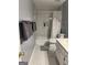 Well-lit bathroom featuring a shower-tub combo, toilet, and marbled tile surround at 30 Highlands Ln, Oxford, GA 30054