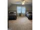 Spacious bedroom featuring two beds, a ceiling fan, and a window that provides natural lighting at 30 Highlands Ln, Oxford, GA 30054