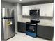 Bright kitchen with stainless steel appliances, two-tone cabinets, and stone countertops at 30 Highlands Ln, Oxford, GA 30054